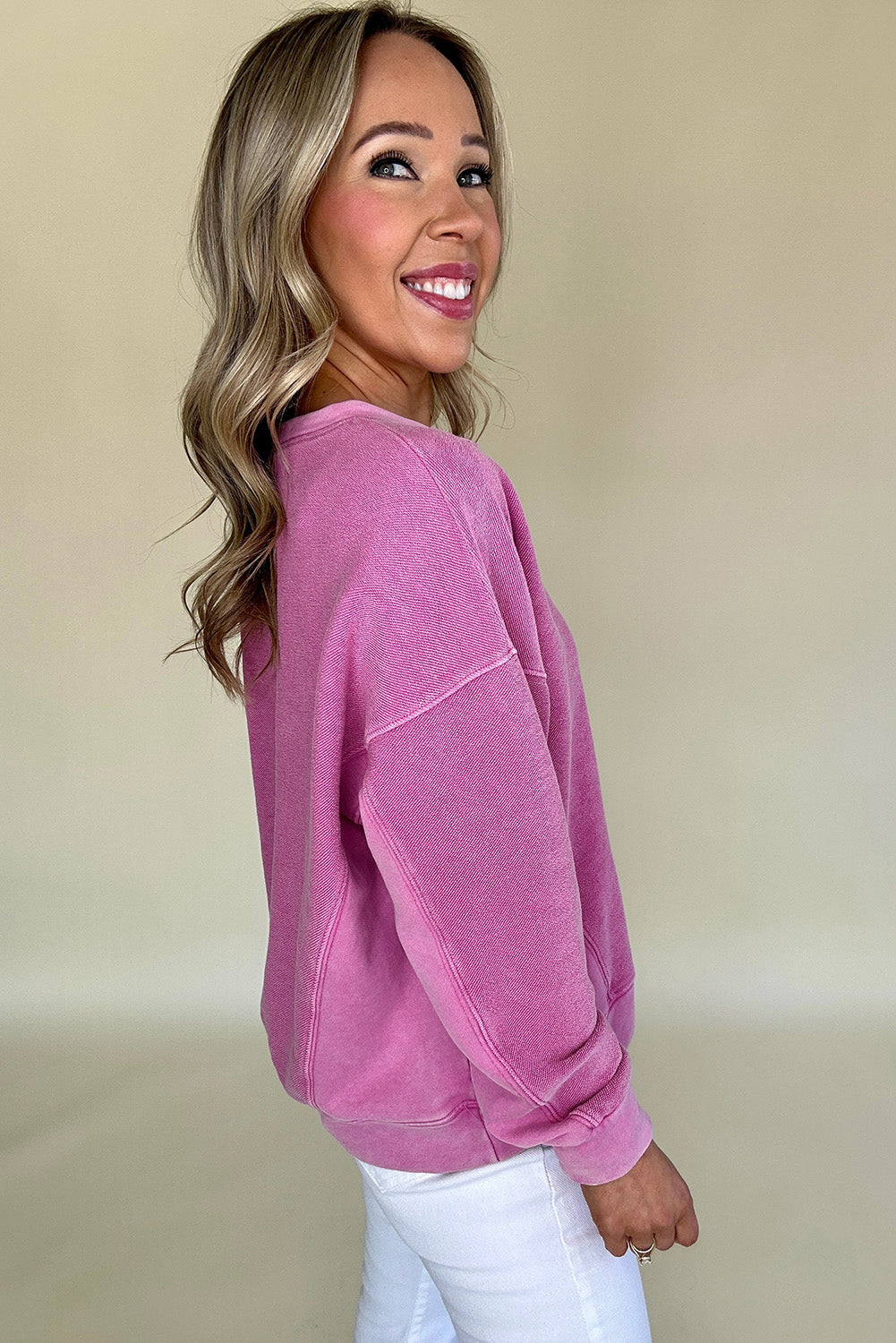 Hot pink sweatshirt with dropped shoulders and solid color notched collar