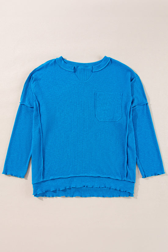 Blue long sleeve v-neck ribbed knit top with exposed seams