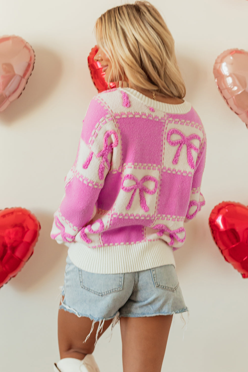 Pull col rond à carreaux bicolore rose avec nœud papillon