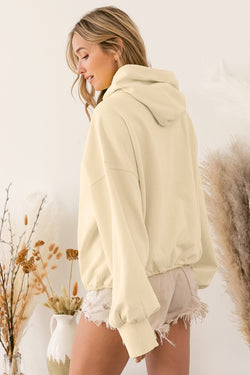 Beige zip-up hoodie with kangaroo pocket and ribbed trim