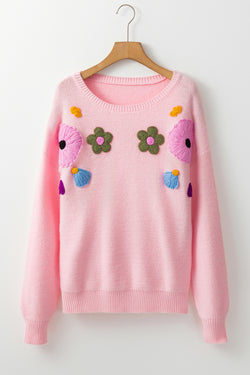 Pink knitted sweater with ribbed edges and flower pattern