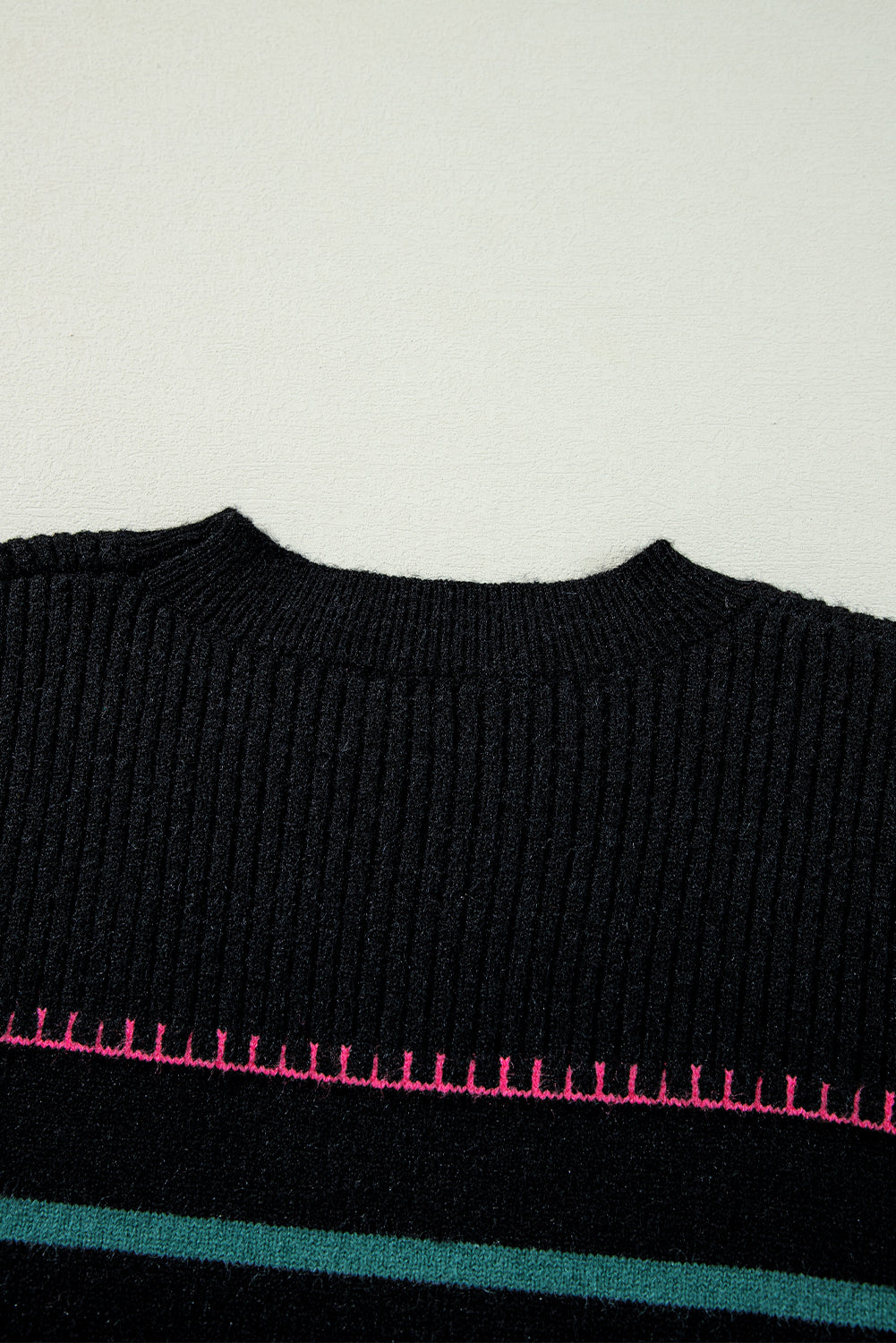 Black sweater with ribbed edges and colorful stripes