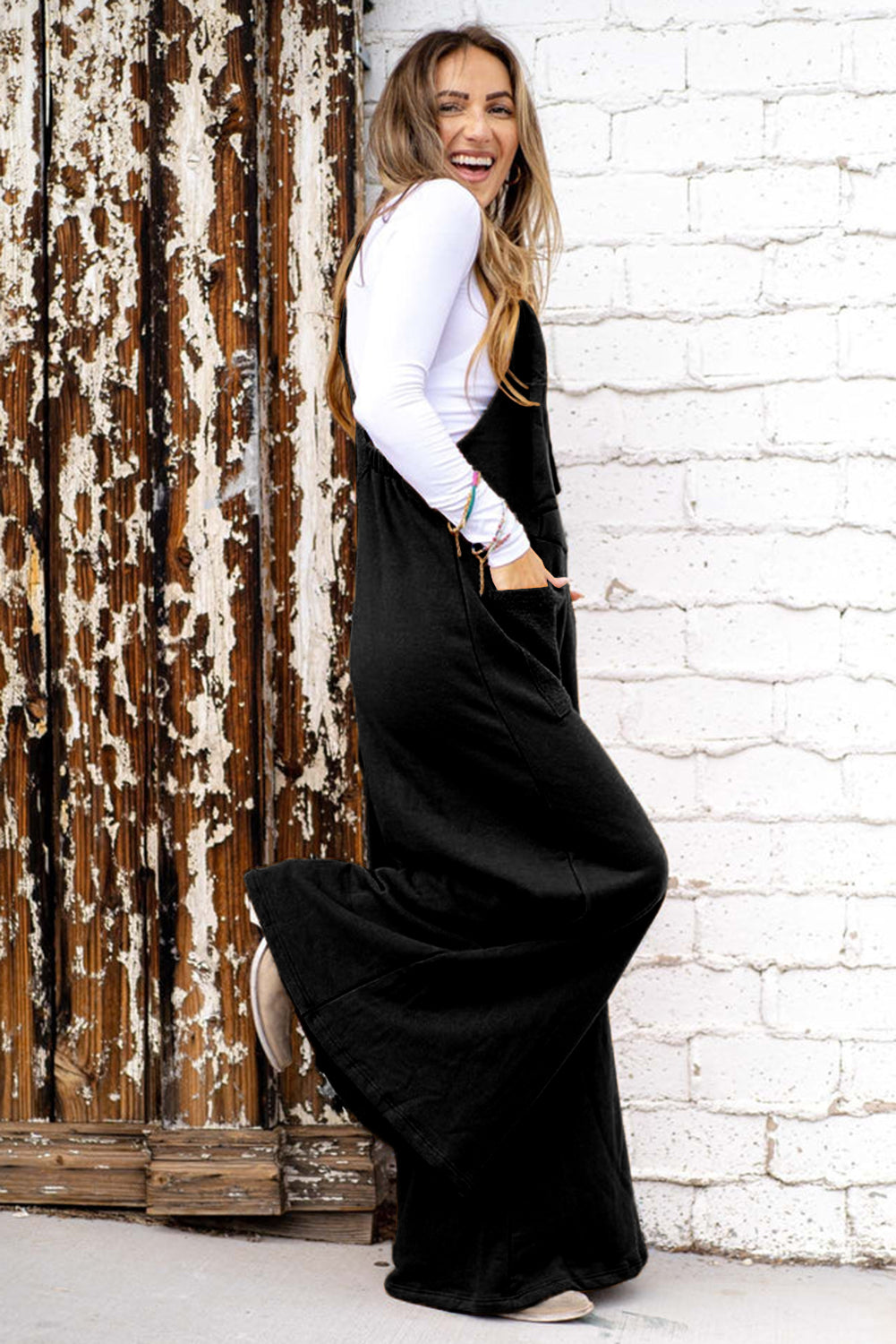 Black wide leg jumpsuit with knotted straps and patch pocket