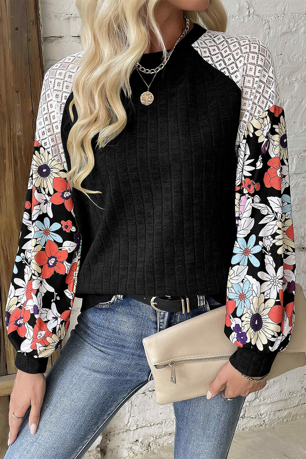 Black ribbed blouse with long sleeves and floral patchwork