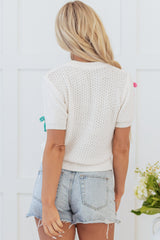 Pull blanc à col montant et nœud coloré