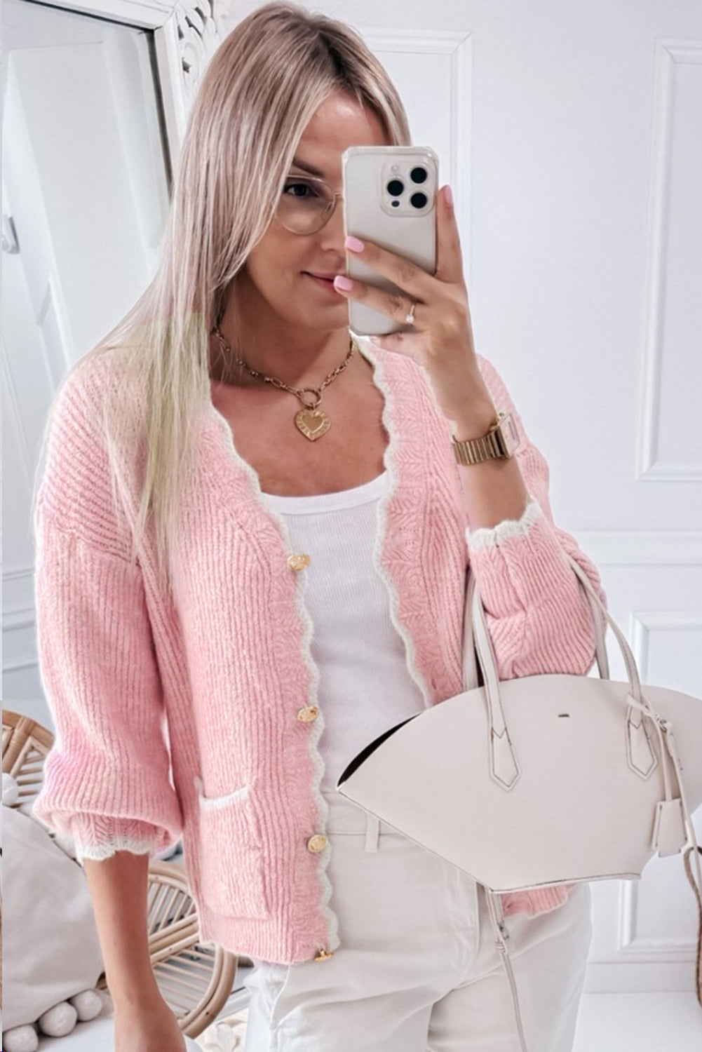 Pink ribbed knit button-up cardigan with side pockets and scalloped edges