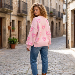 Pull ample rose à motifs cœur et manches bouffantes