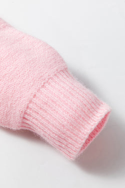 Pink knitted sweater with ribbed edges and flower pattern